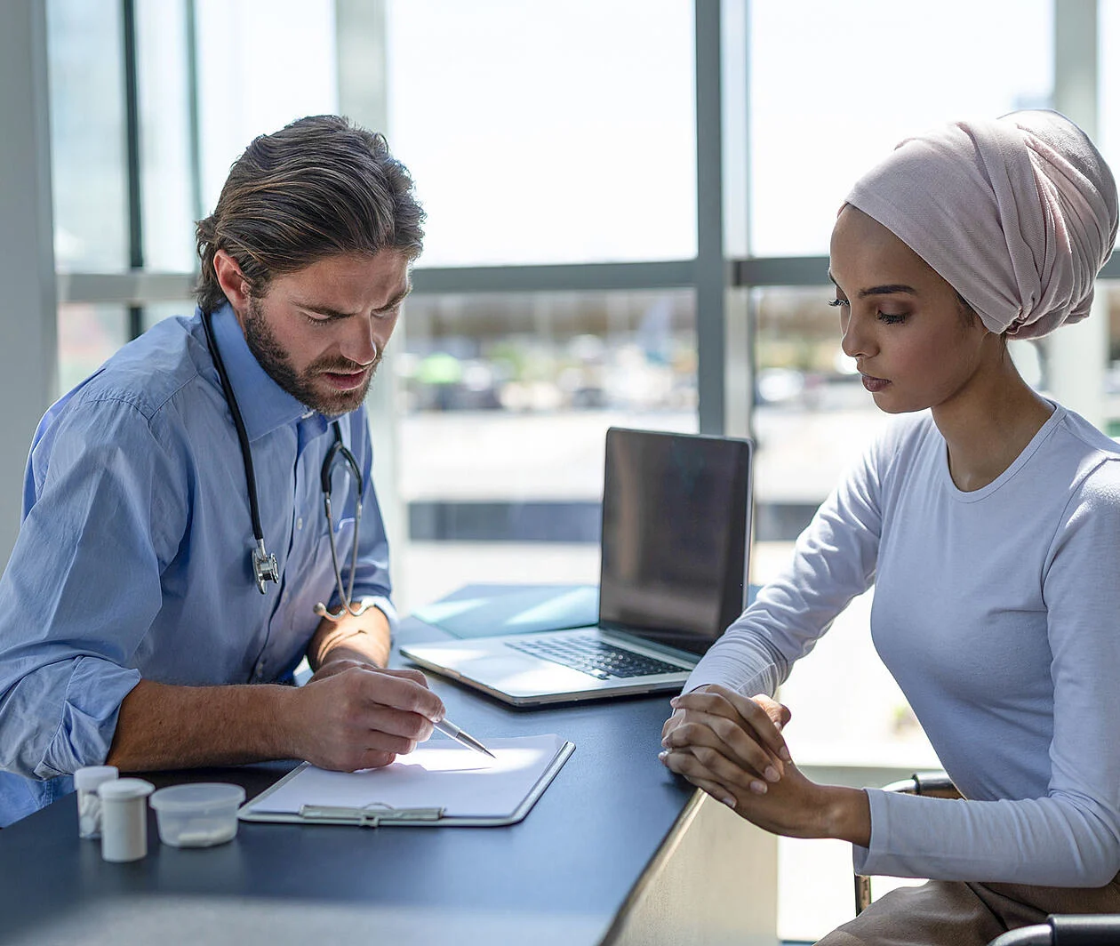 A healthcare professional consulting with a patient