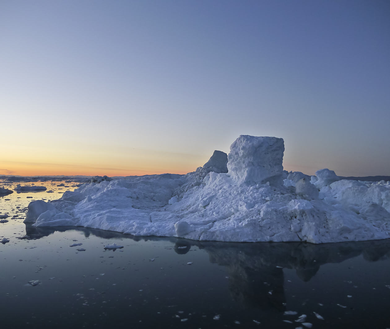 Iceberg melting in sunset