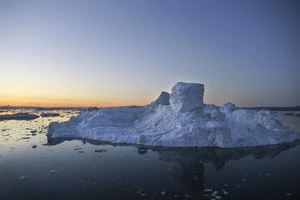 Iceberg melting in sunset