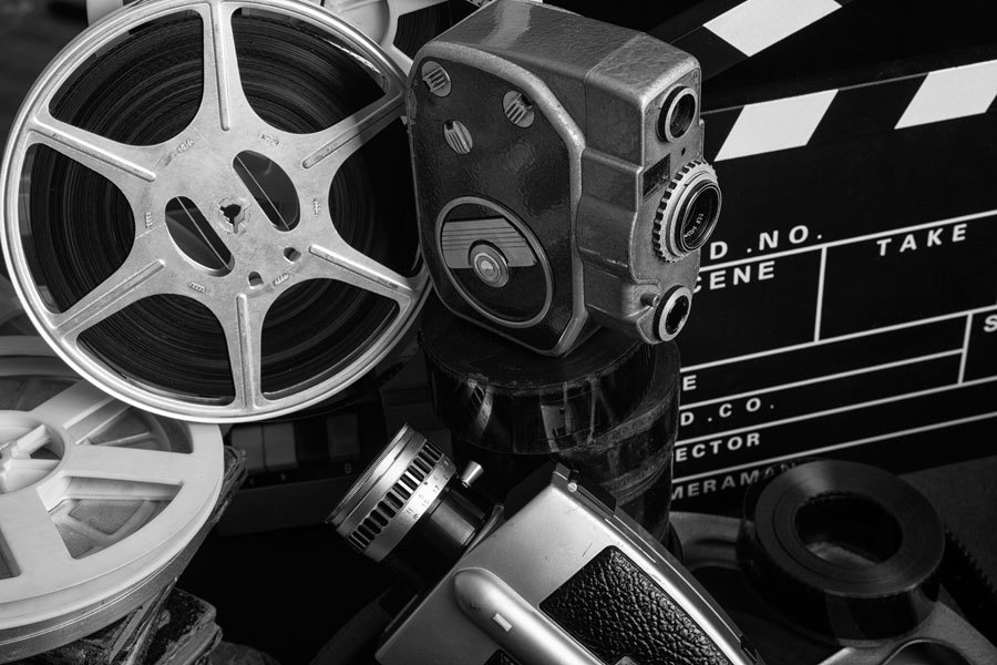 Old style film cameras with film reels and clapperboard