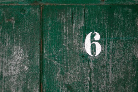 A number 6 on a gnarly old wooden door or something