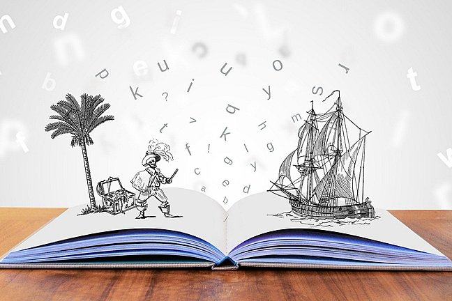 An open book with letter flying off as well drawings of a pirate, a treasure and a pirate boat