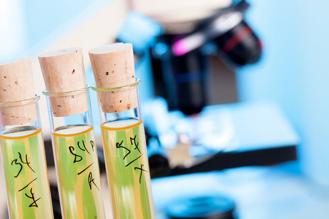 Vials with a microscope in the background