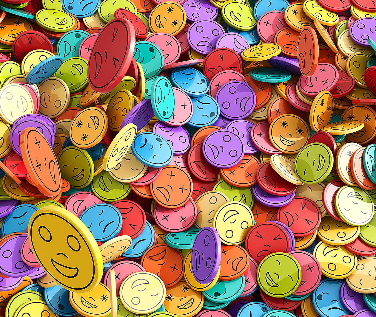 A collection of multi-coloured counters with emojis