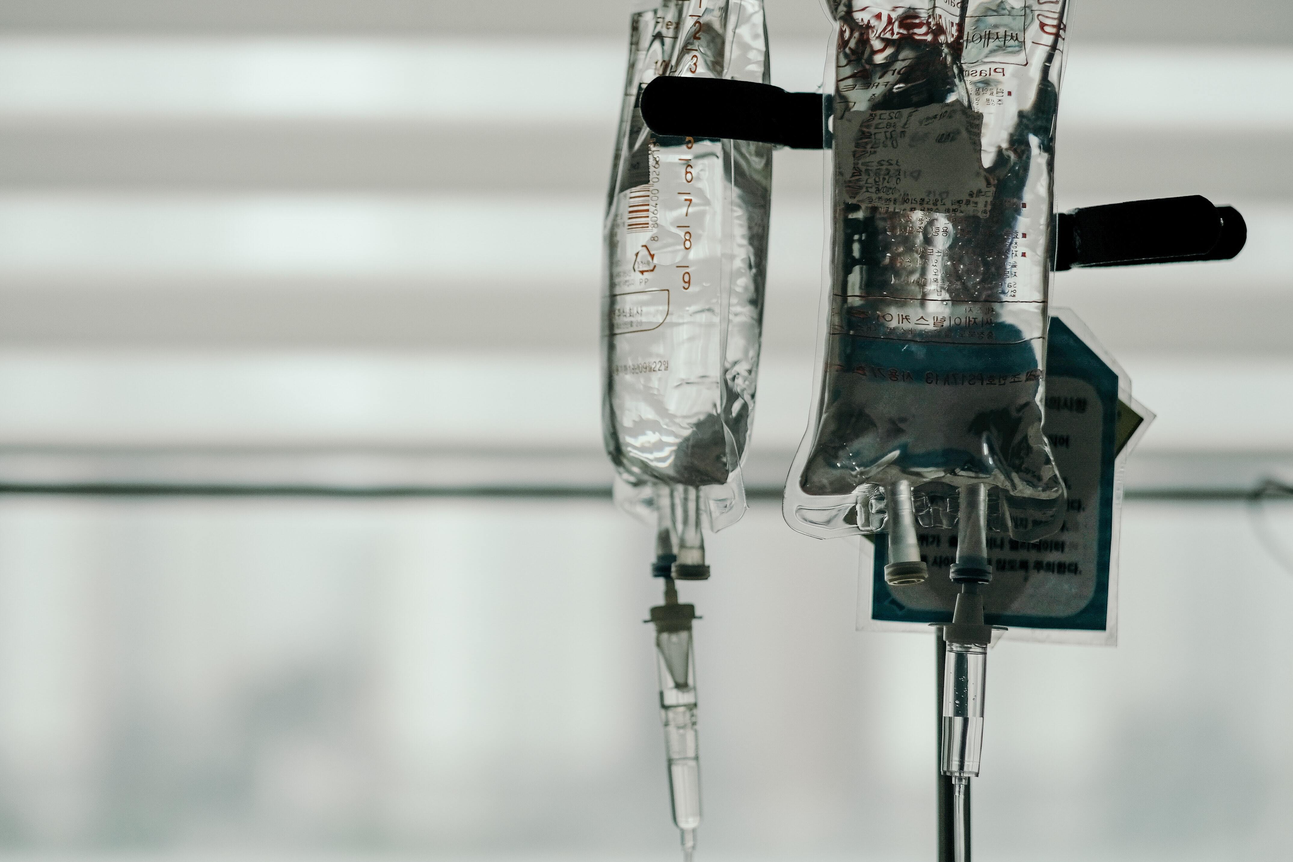 black and white image of IV bag filled with clear liquid