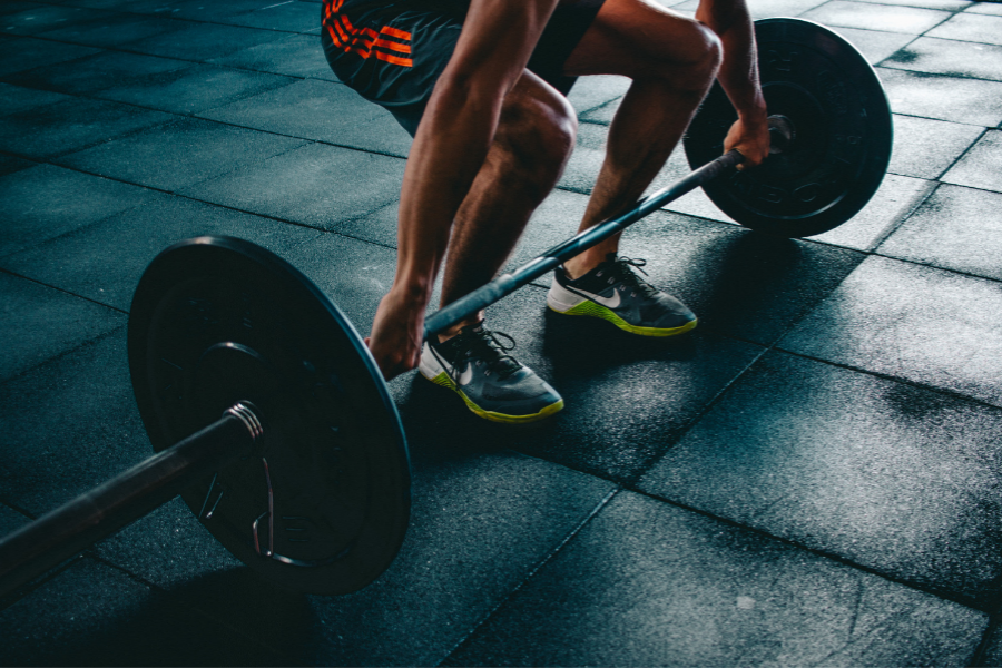 man about to lift weights off floor