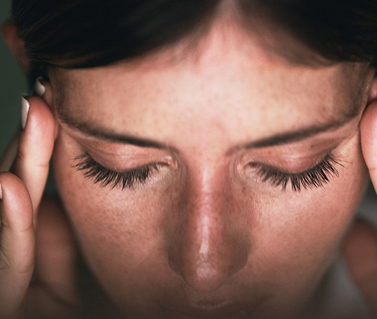 Closeup shot of a young businesswoman looking stressed out while working in an office at night