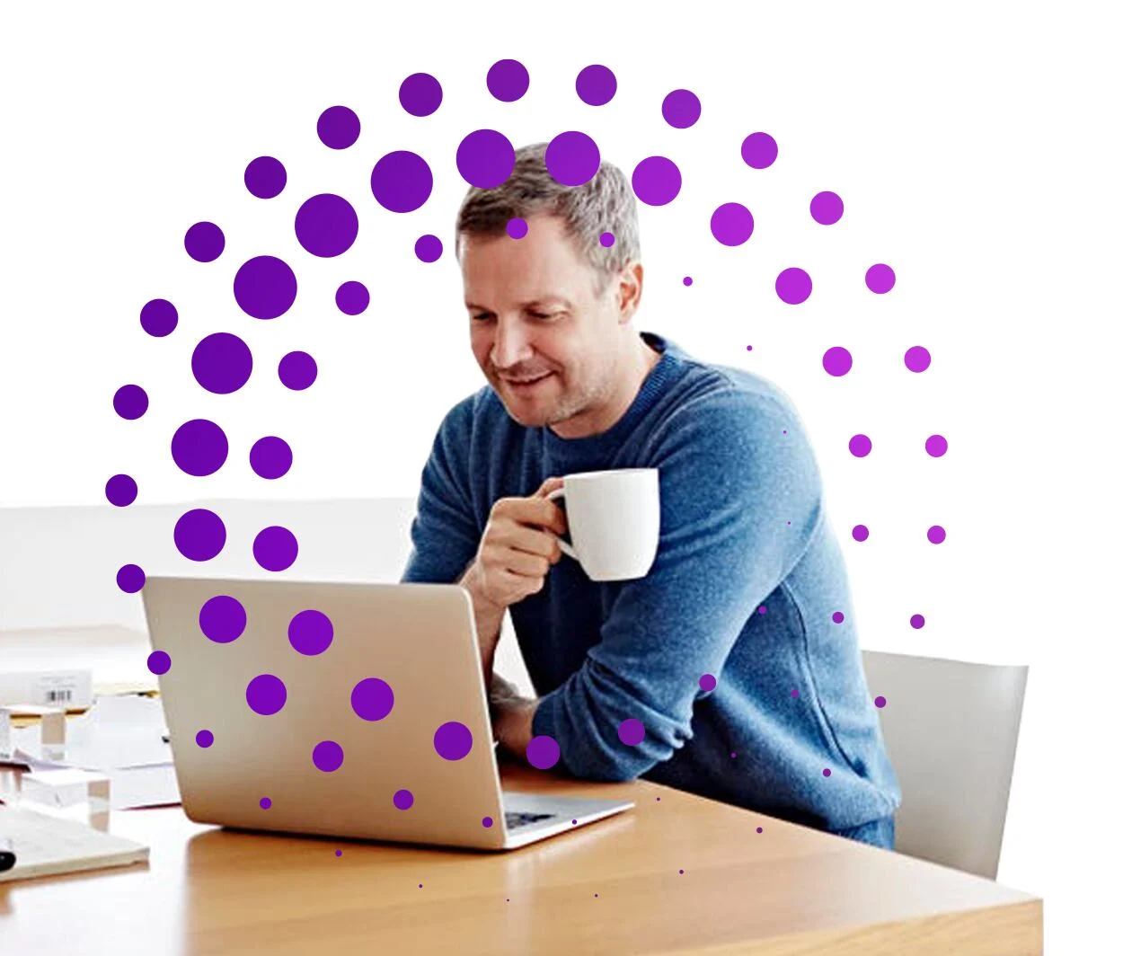 Man working at a laptop drinking coffee