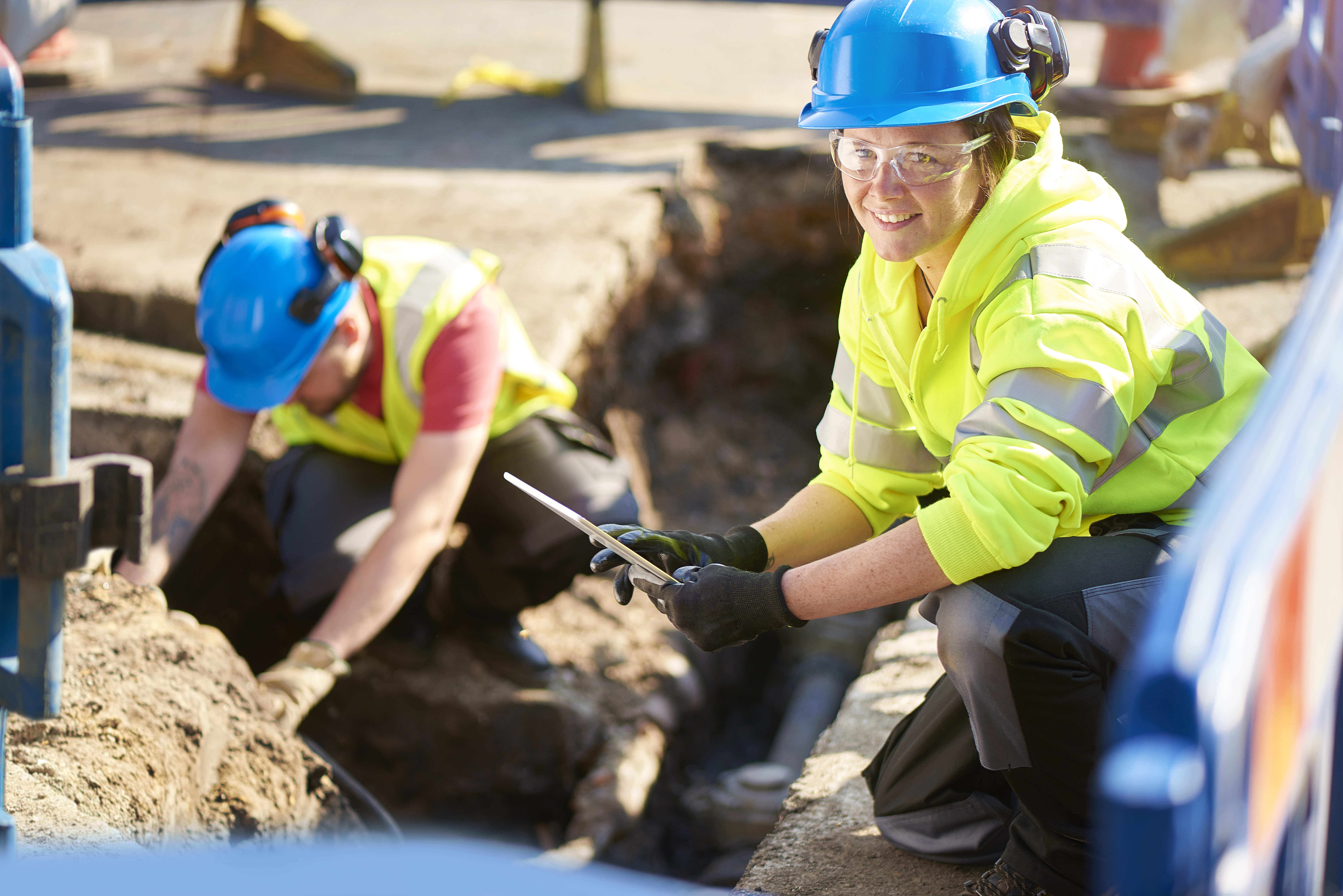 Young woman builder wearing hard hat and high vis