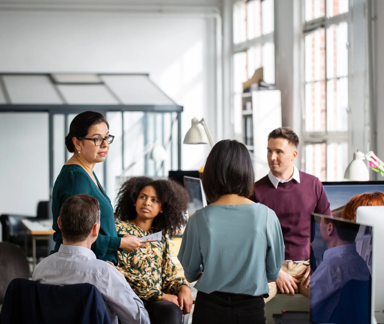 Group of business people in different ethnic group having a brainstorming session in office. Businesswoman talking to her colleagues in a meeting.