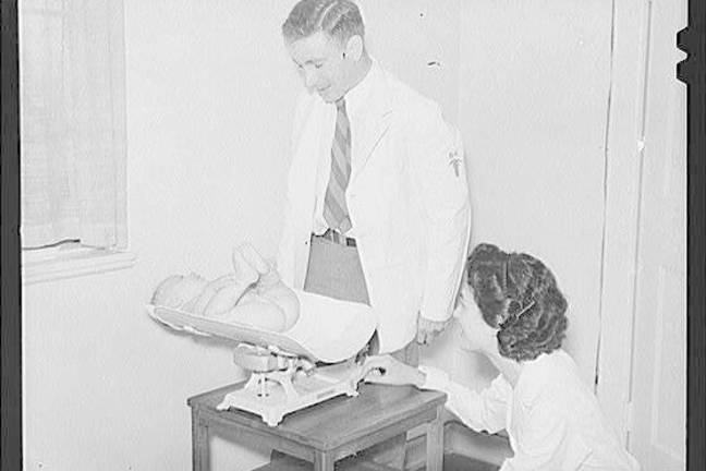 Image of weighing a baby at a medical centre.