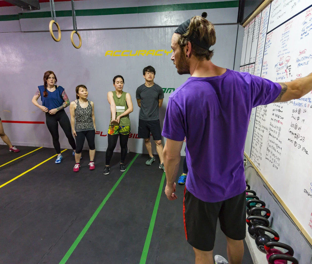 A sports coach speaks to a group 