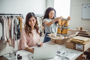 Two people working in a clothes business