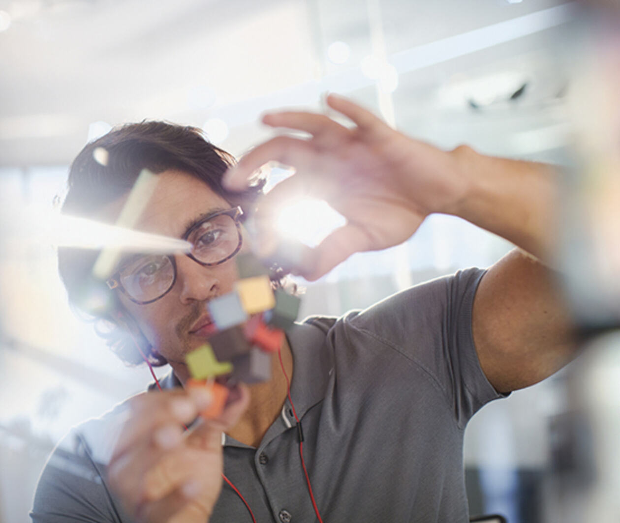 Focused, innovative male entrepreneur examining prototype