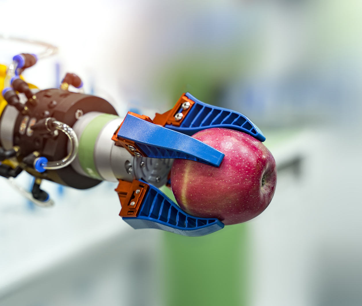 Robotic arm holding an apple in a science lab 