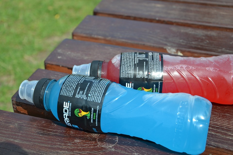 Two commercially available sports drinks, one containing a blue liquid, the other red.