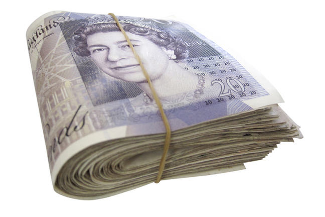 This is a photo of a wad of £20 bank notes held together by an elastic band.