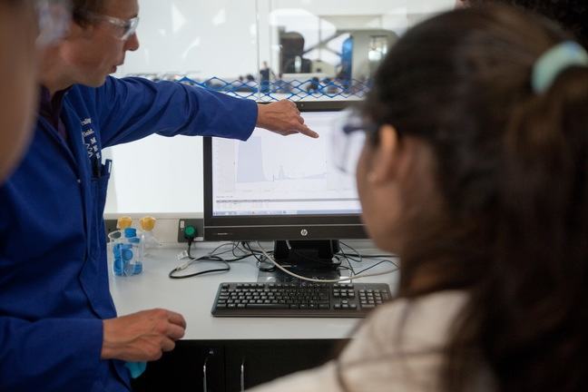 A technician explains a computer read out to a student