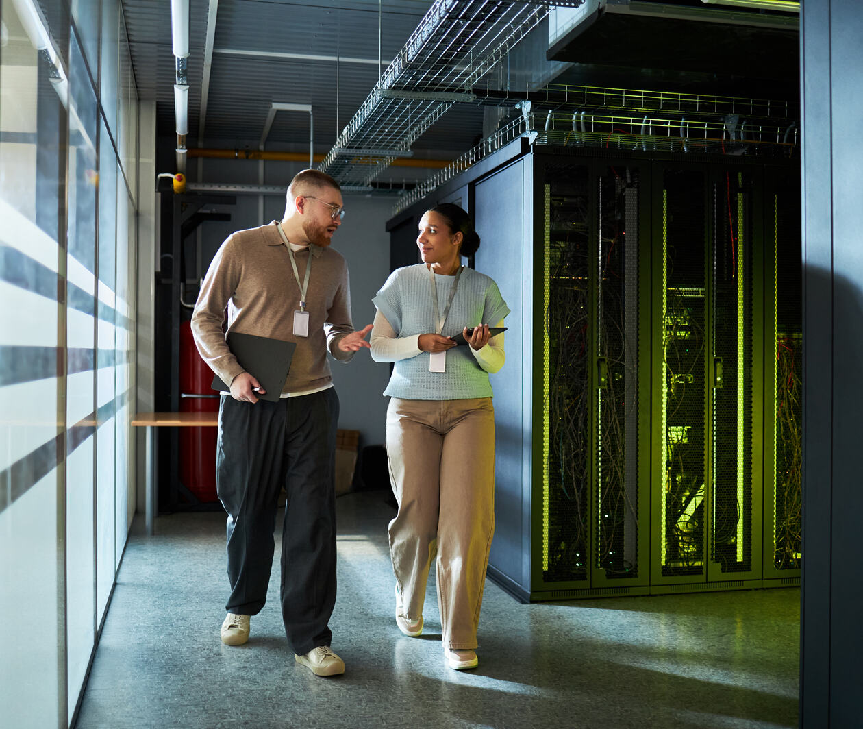 A man and woman walking past a data processor