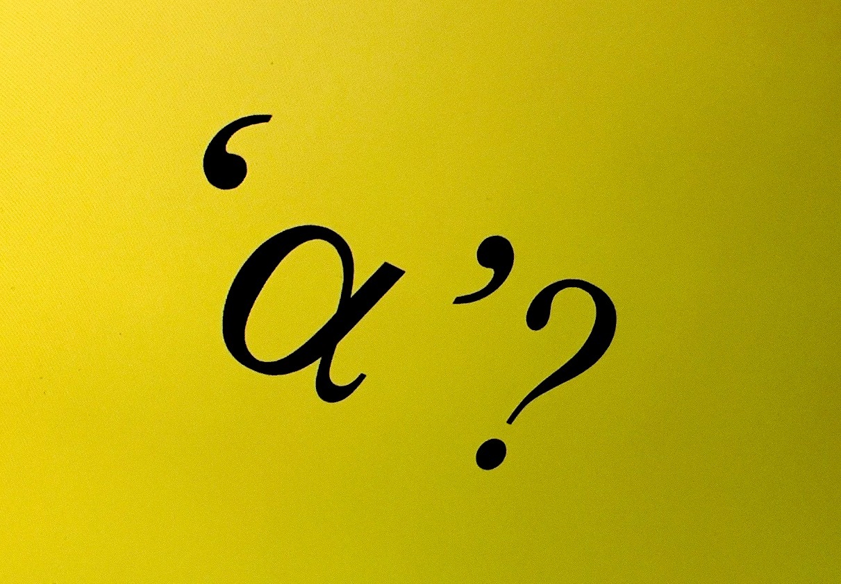 A close up of a letter alpha followed by a question mark