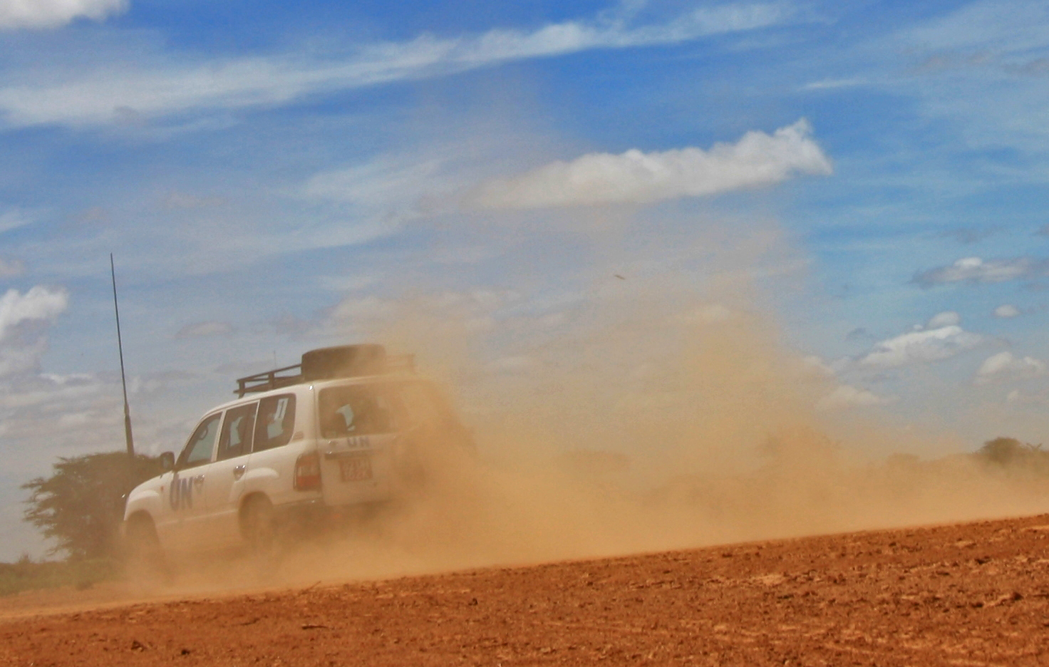 Movement to and from the Dadaab refugee camp Image of jeep driving away with dust