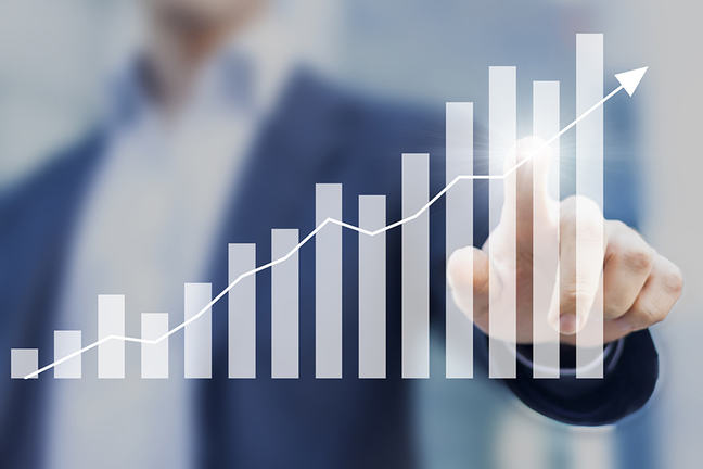 Business success with growing, rising charts and businessman in the background.
