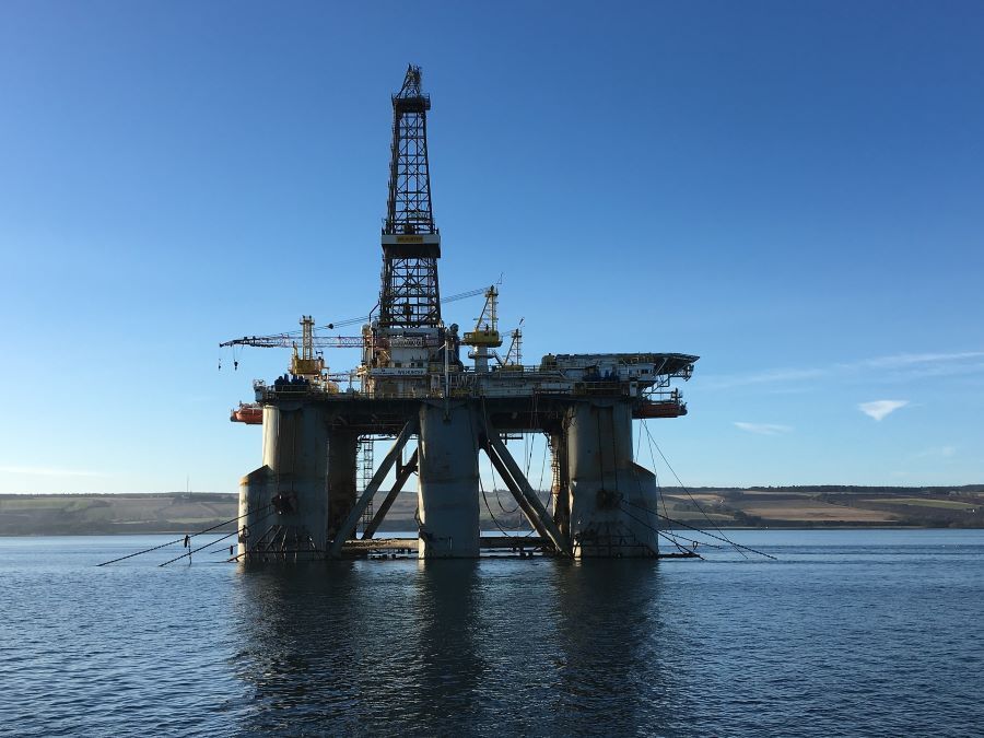 An oil rig stands in the middle of the sea