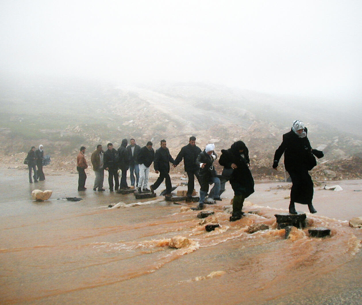 Refugees crossing a river