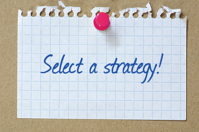 An image of a piece of paper pinned to a corkboard with Select a Strategy written on it.