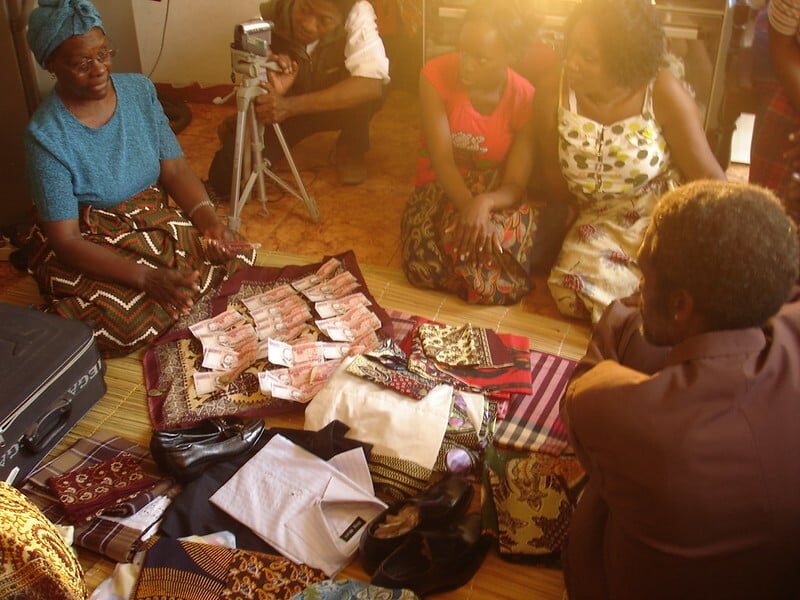 People counting money on the floor.