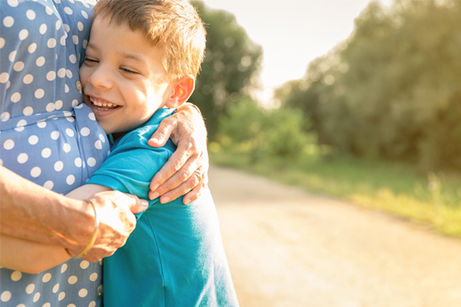 Boy hugging a woman