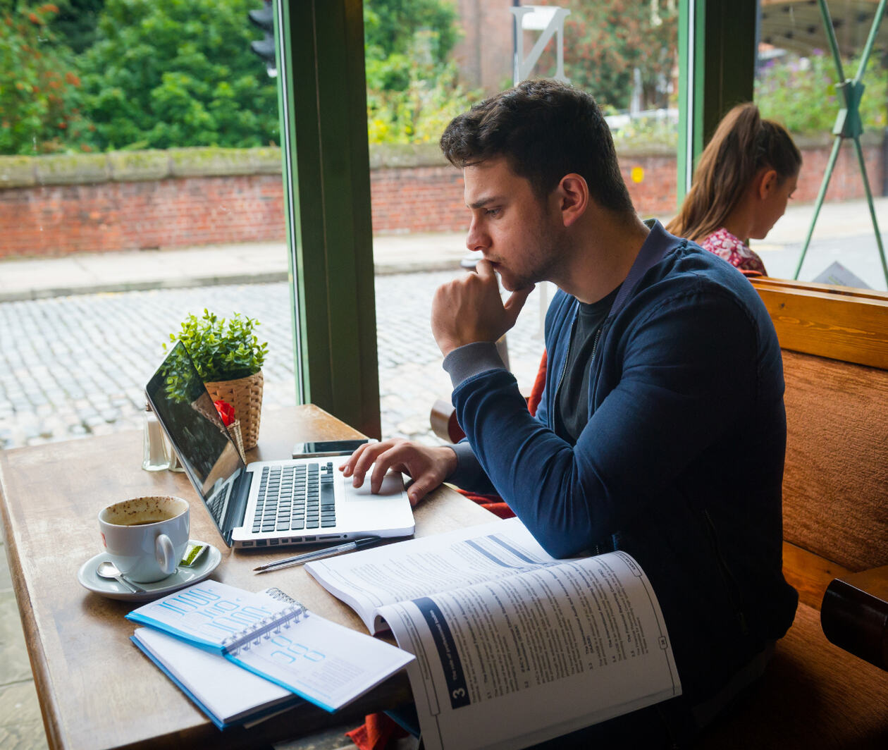 Man sat at a table working on this laptop 