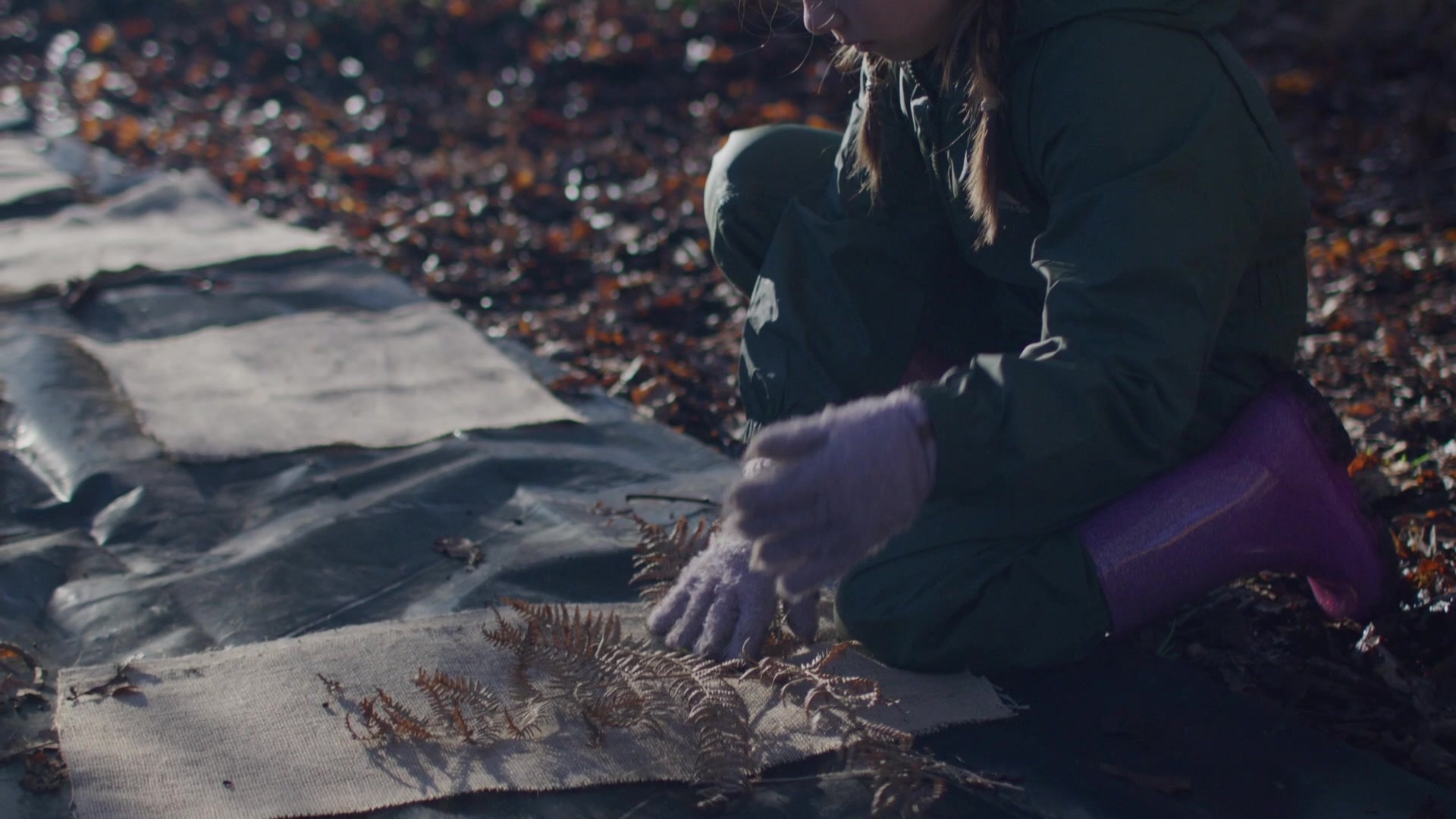 A child examining a leaf