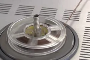 An image of a 3.75 inch reel-to-reel magnetic tape running through a tape machine