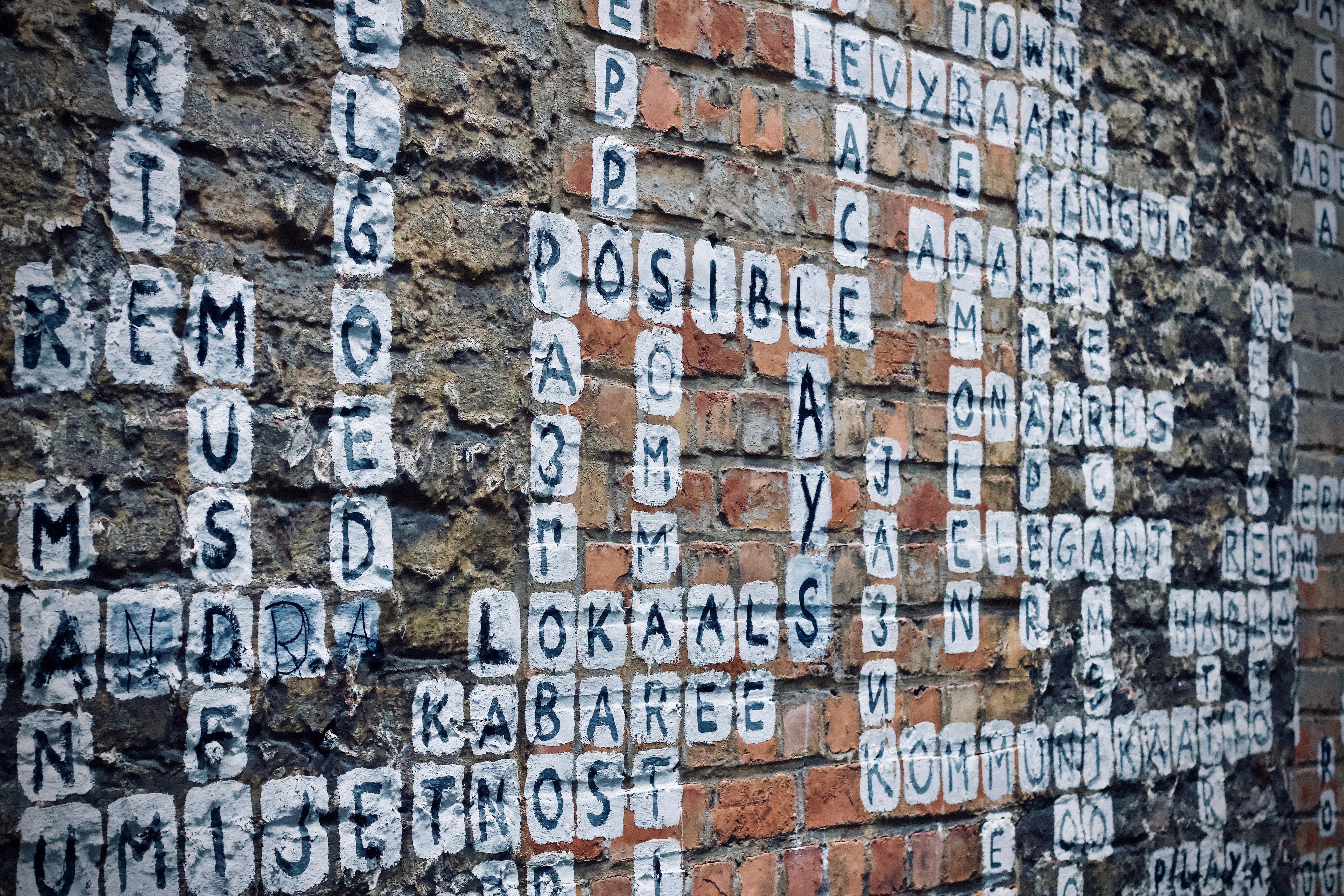 words painted on a wall like crosswords