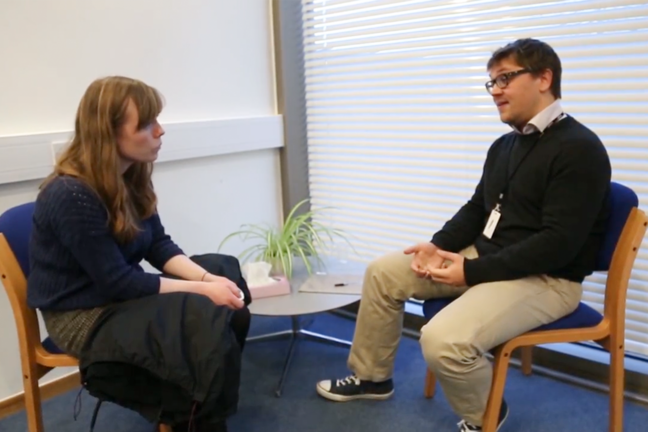 Dr Jon Roberts in a genetic counselling session with a young adult, female patient, discussing the result of her screening for Huntington's disease