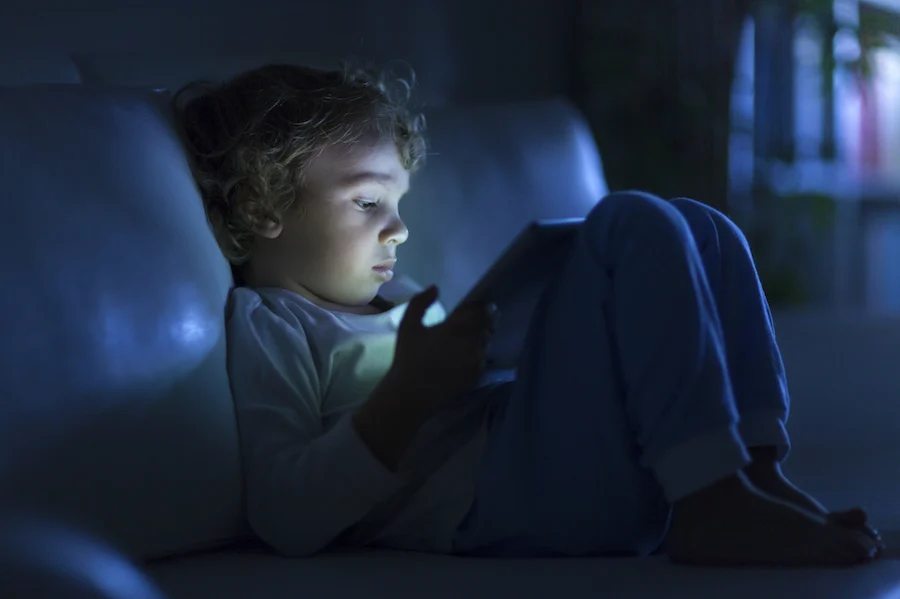 a young students on their ipad in the dark