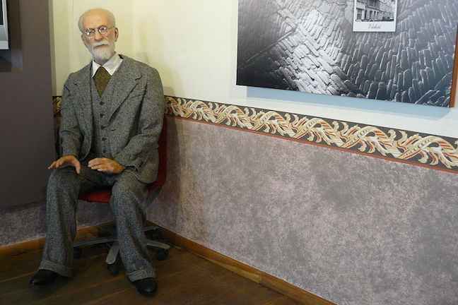 Figure of Sigmund Freud sitting in the corner of a room