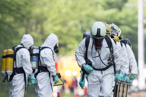 Men in hazmat suits and self-contained breathing apparatus