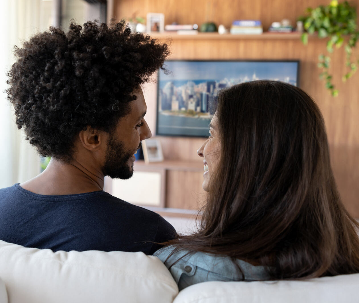 Multi-ethnic couple watching TV