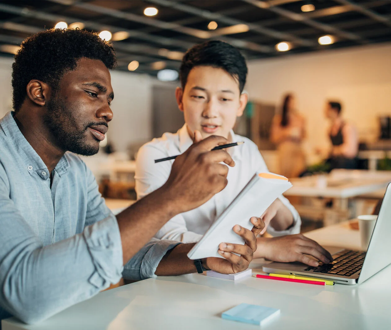 Young multi ethnic-group of people discussing about writing an essay.