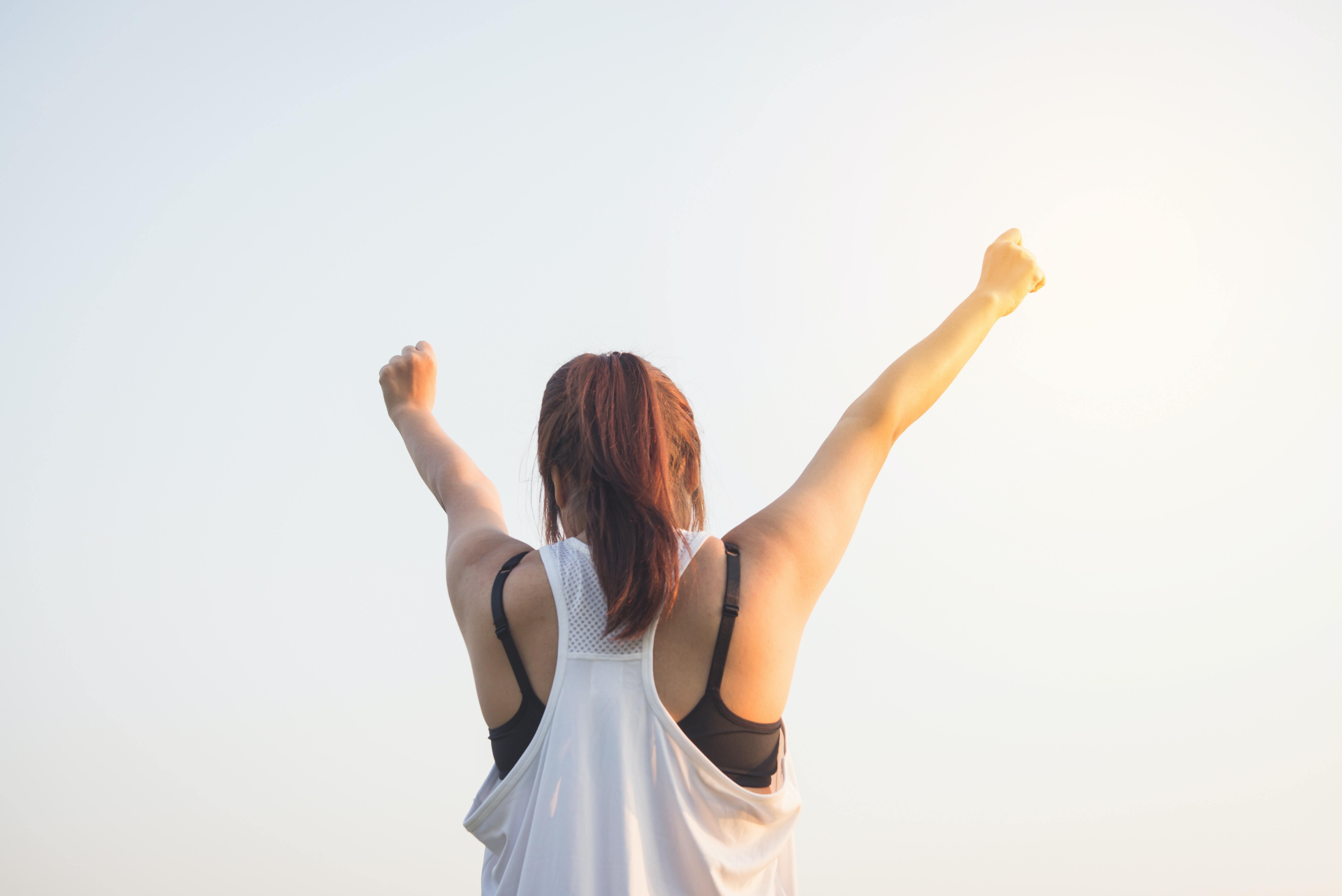 a woman pumping her hands in the air