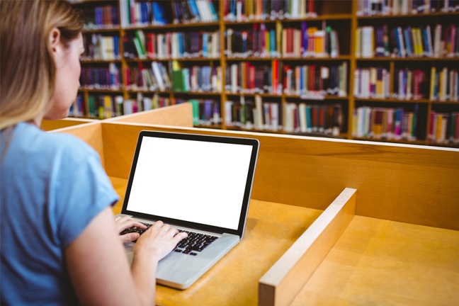 Woman using laptop in library