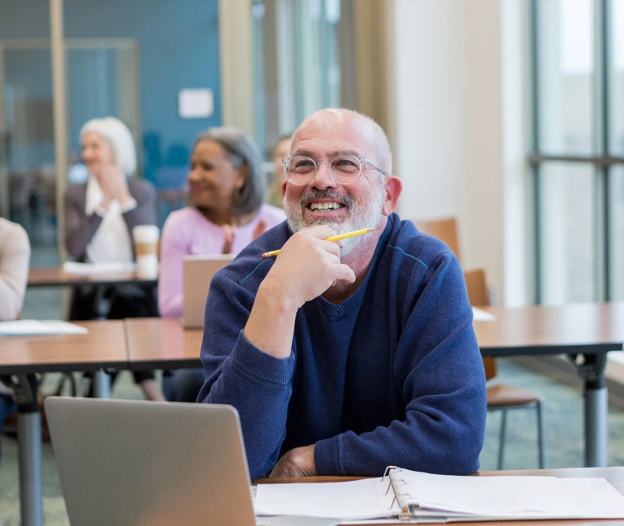 Diverse group of students have fun during their adult creative writing class at the local college.