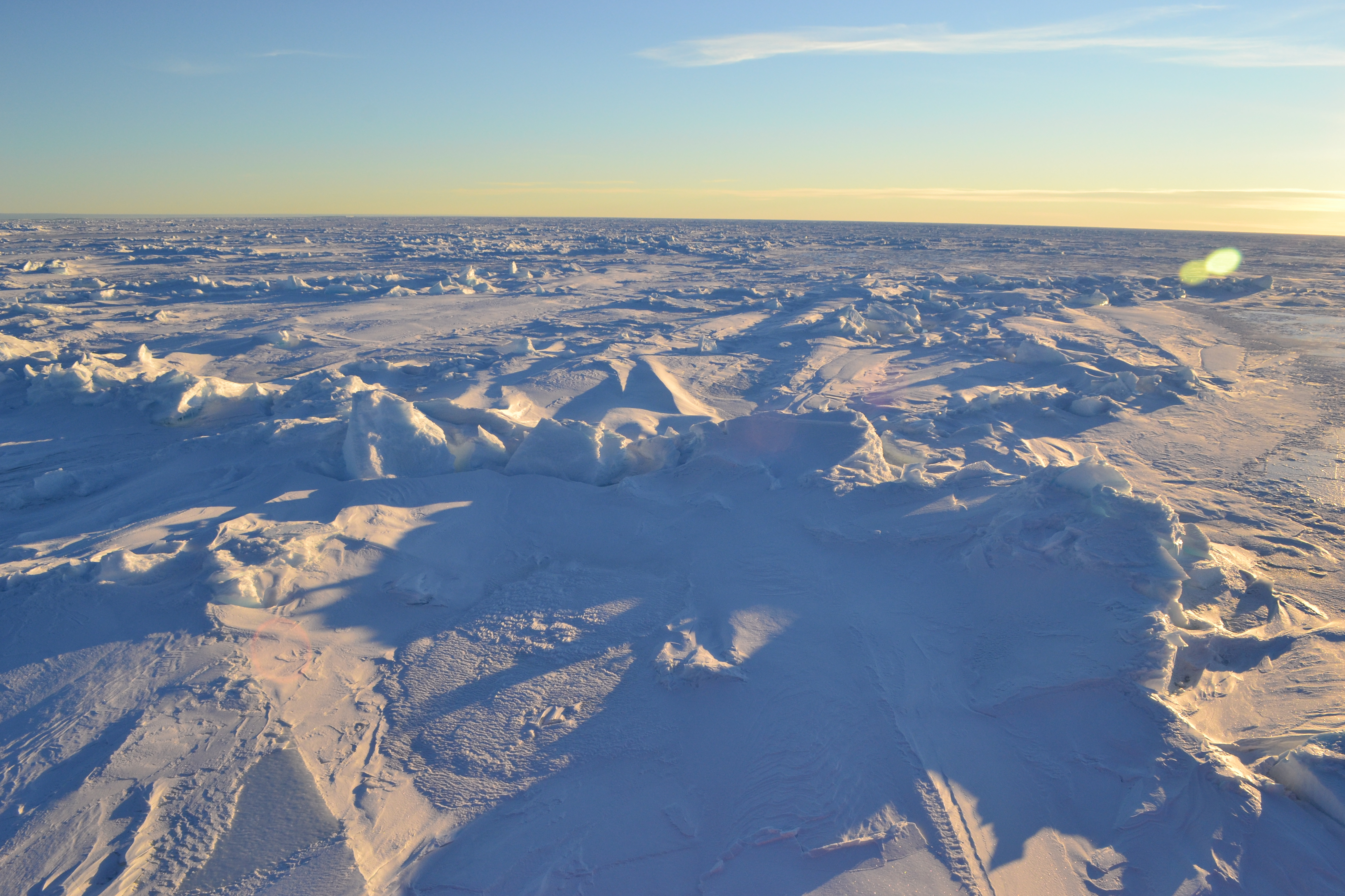 An above water view of cracked sea ice