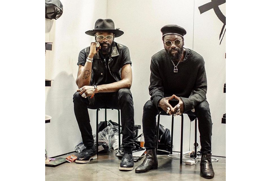 Sam and Shaka sitting on stools facing the camera.