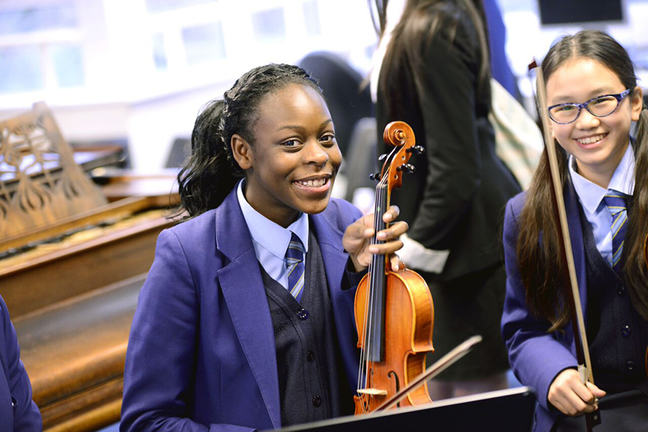 Girls playing string instruments
