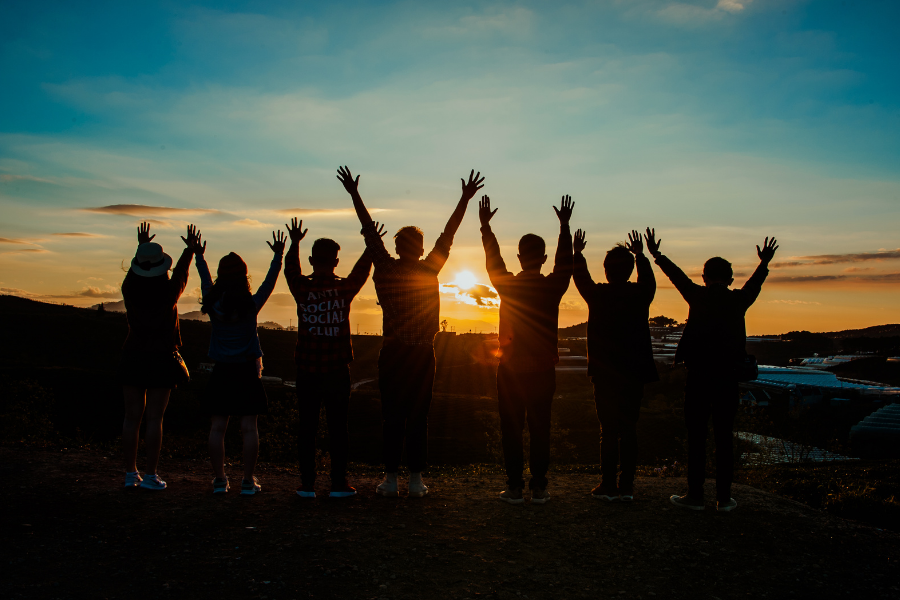 group standing watching the sunrise