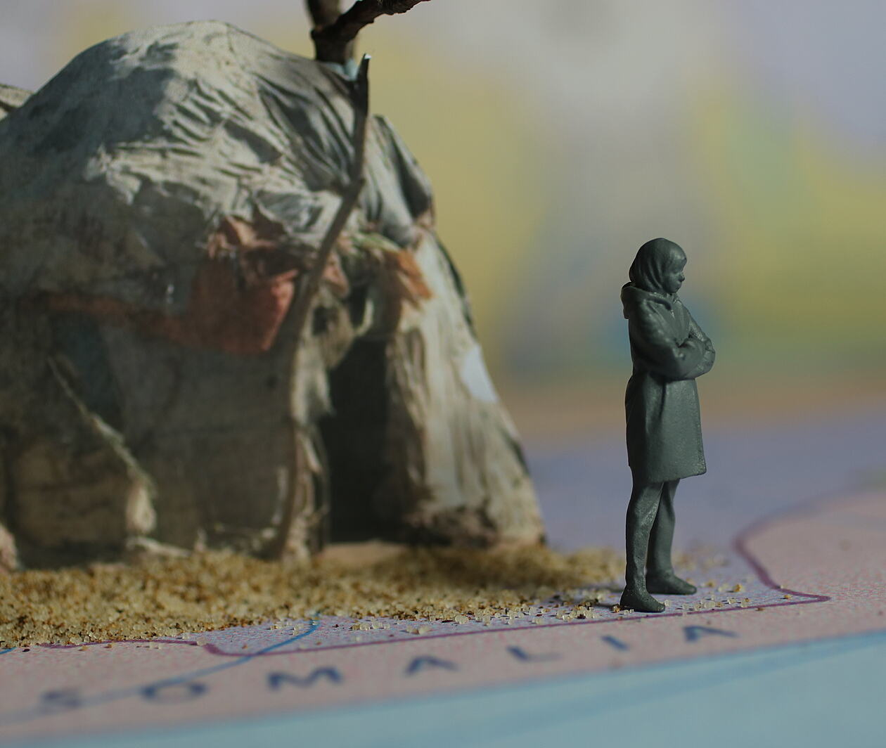 A female figurine, standing on a map showing Somalia