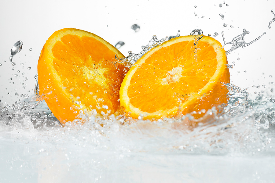 Orange cut in half water splash